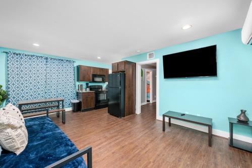 a living room with a couch and a flat screen tv at Chic 1BR Stay with King Bed and Free Park in Houston