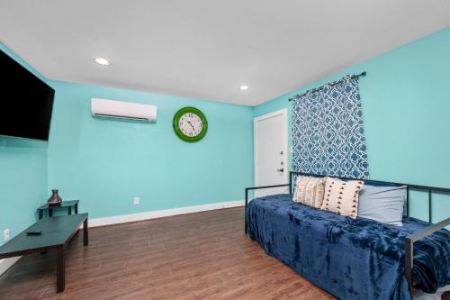 a bedroom with blue walls and a bed and a desk at Chic 1BR Stay with King Bed and Free Park in Houston