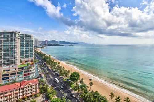 a view of a beach with buildings and the ocean at Sheraton Nha Trang Hotel & Spa in Nha Trang