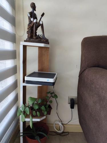 a laptop sitting on a shelf next to a couch at Departamento en Linares in Linares