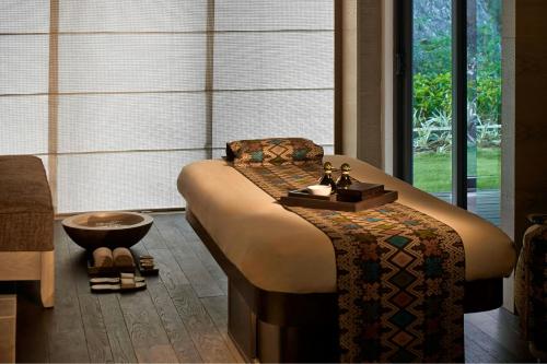 a large bed in a room with a large window at The Ritz-Carlton Bali in Nusa Dua