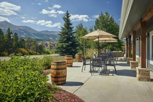 a patio with tables and chairs and an umbrella at Residence Inn by Marriott Breckenridge in Breckenridge
