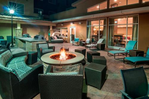 a patio with chairs and a fire pit in a building at Residence Inn by Marriott Rapid City in Rapid City