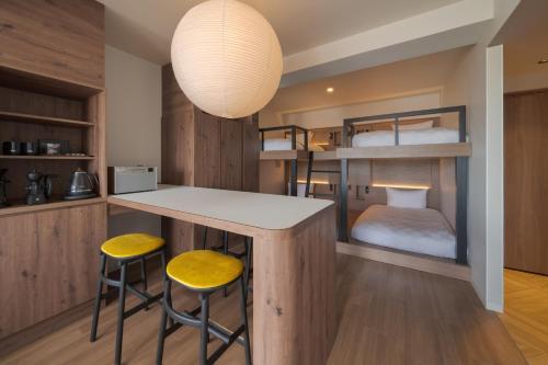 a kitchen with two bunk beds in a room at the b osaka-shinsekai in Osaka
