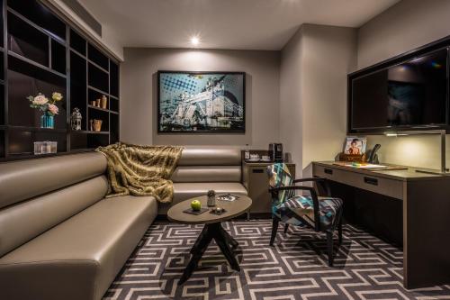 a living room with a couch and a table at Courthouse Hotel Shoreditch in London