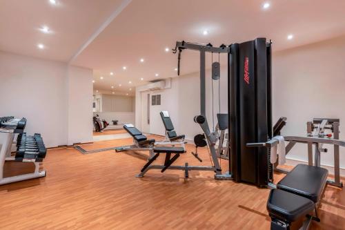 a gym with treadmills and machines in a room at Stuttgart Marriott Hotel Sindelfingen in Sindelfingen