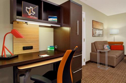 a hotel room with a desk and a couch at TownePlace Suites Fort Worth Southwest TCU Area in Fort Worth