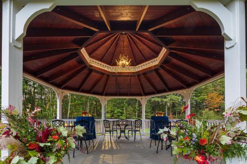 a pavilion with tables and chairs and a chandelier at Portland Sheraton at Sable Oaks in South Portland