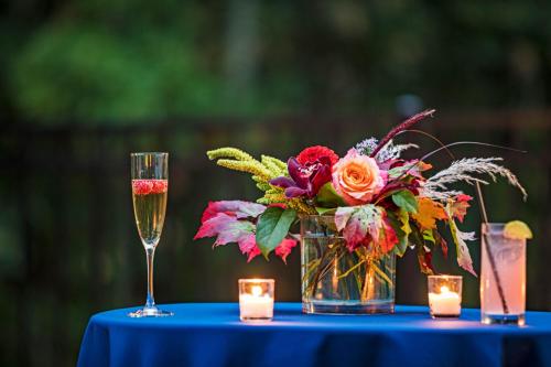 a blue table with a vase of flowers and candles at Portland Sheraton at Sable Oaks in South Portland
