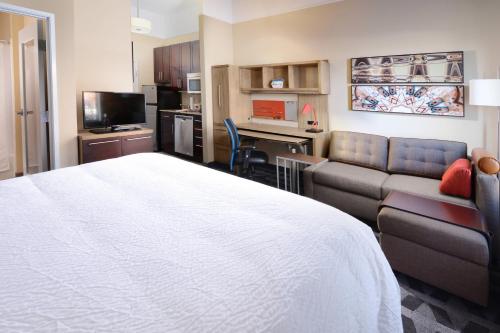 a hotel room with a bed and a couch at TownePlace Suites by Marriott Houston Galleria Area in Houston