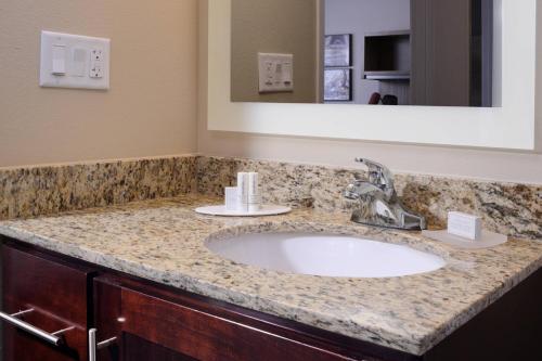 a bathroom with a sink and a mirror at TownePlace Suites by Marriott Houston Galleria Area in Houston
