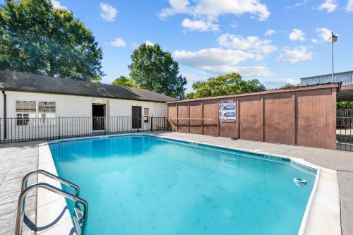 a swimming pool in front of a building at Modern Studio Retreat with King Bed, Full Kitchen & Free Park in Houston