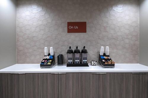 a counter with bottles of wine on top of it at TownePlace Suites by Marriott Dallas DFW Airport North/Irving in Irving