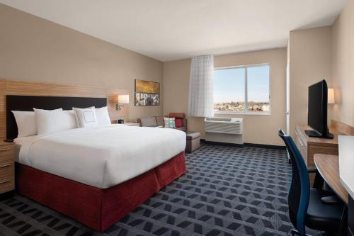a hotel room with a large bed and a desk at TownePlace Suites by Marriott Twin Falls in Twin Falls