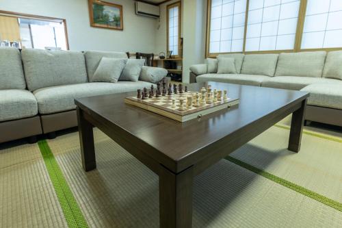 a living room with a chess board on a coffee table at Welcome Nozawa in Nozawa Onsen