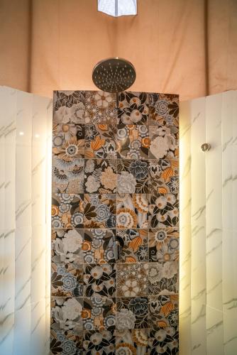 a bathroom with a wall with a floral pattern at The Dewi Kintamani Luxury Glamping and Natural Hotspring in Kintamani
