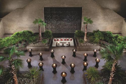 an overhead view of a garden with palm trees and lights at Ritz Carlton DIFC Downtown Dubai in Dubai