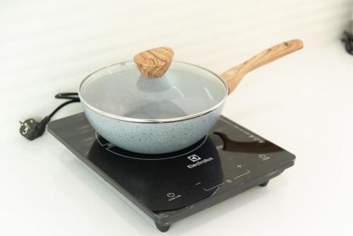 a bowl on top of a stove with a wooden spoon at Turtle Tales-Mafueang,Turtle Beach,Phang-Nga in Phang-nga