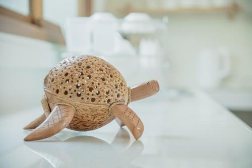a stuffed turtle toy sitting on a table at Turtle Tales-Mafueang,Turtle Beach,Phang-Nga in Phang-nga