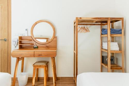 a dressing table with a mirror and a bunk bed at Turtle Tales-Mafueang,Turtle Beach,Phang-Nga in Phang-nga