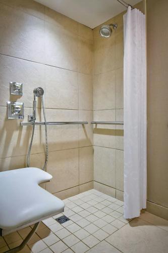 a bathroom with a shower with a shower curtain at Sheraton New York Times Square Hotel in New York
