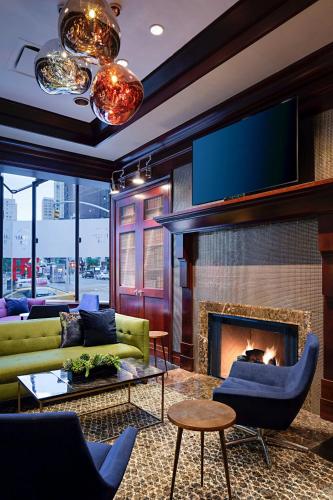a living room with a fireplace and a tv at Sheraton New York Times Square Hotel in New York