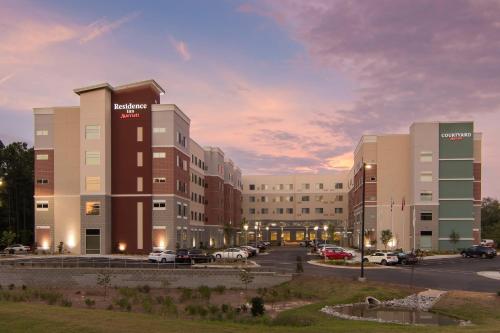 a rendering of a hospital with cars parked in a parking lot at Residence Inn Raleigh-Durham Airport/Brier Creek in Raleigh