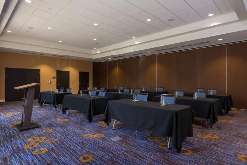 a conference room with black tables and a podium at Residence Inn Raleigh-Durham Airport/Brier Creek in Raleigh