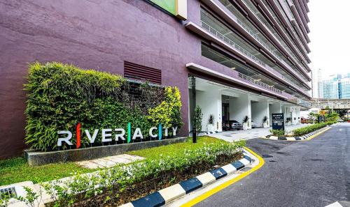 a purple building with a sign on the side of it at Riveria City near KL Sentral with 118 view Sky Infinity Pool by COBNB in Kuala Lumpur