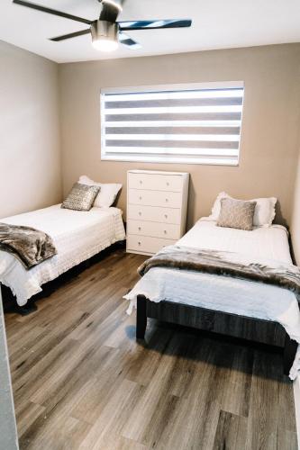 a bedroom with two beds and a window at Welcome to 305 Rentals in Miami Gardens