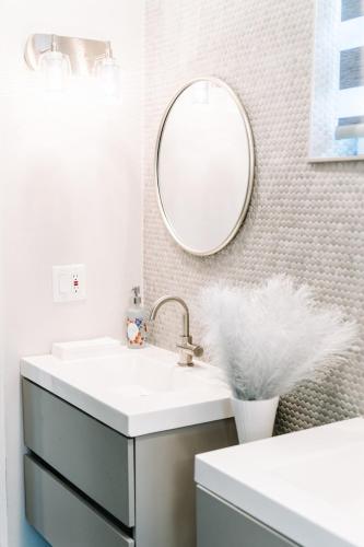 a bathroom with a sink and a mirror at Welcome to 305 Rentals in Miami Gardens