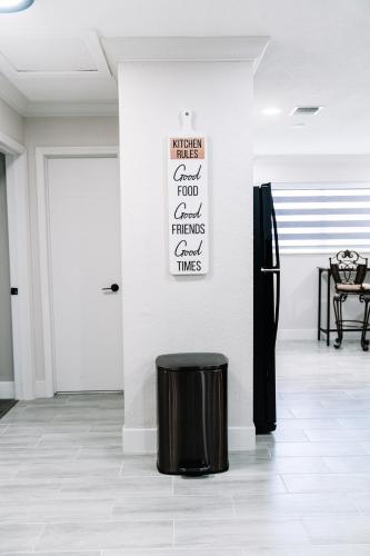 a black stool in a room with a white wall at Welcome to 305 Rentals in Miami Gardens