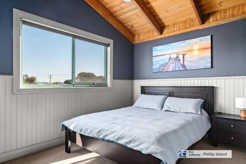 a bedroom with a bed and a large window at Island Escape with 12m Indoor Pool in Surf Beach