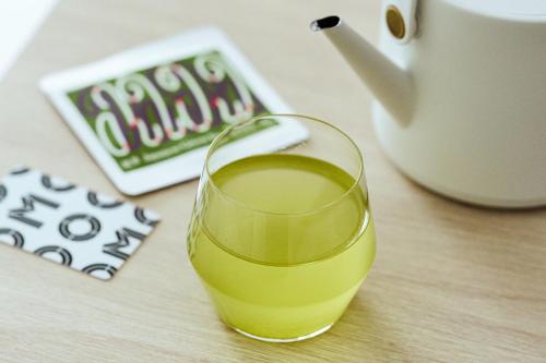 a glass of wine sitting on top of a table at OMO3 Tokyo Akasaka by Hoshino Resort in Tokyo