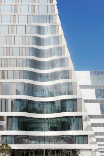 a tall glass building with a lot of windows at JW Marriott Marquis Hotel Shanghai Pudong in Shanghai
