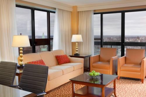 a living room with a couch and chairs and windows at Ottawa Marriott Hotel in Ottawa