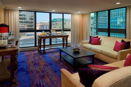 a living room with a couch and a table at Ottawa Marriott Hotel in Ottawa