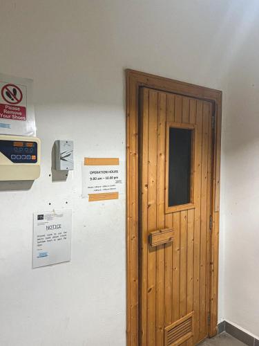 a wooden door and a sign on a wall at Serdang, 1-6pax, Near MRT, Near Pavilion in Serdang