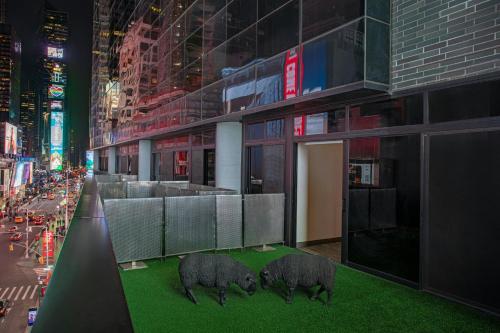a rendering of three pigs on a building at Renaissance New York Times Square by Marriott in New York
