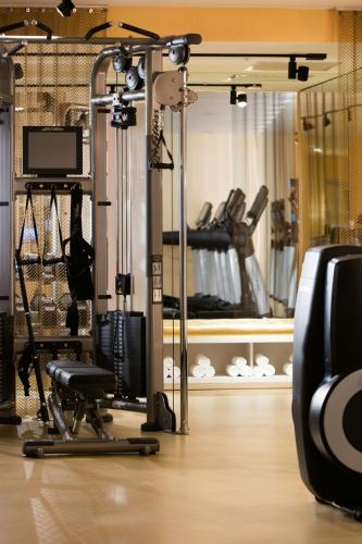 a room with a gym with a chair and a tv at Renaissance New York Times Square by Marriott in New York