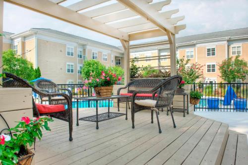 a patio with a table and chairs and a pergola at Residence Inn by Marriott Chapel Hill in Chapel Hill