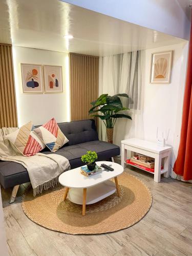 a living room with a couch and a table at La Bella Residences, The Tiny Loft in Tagaytay