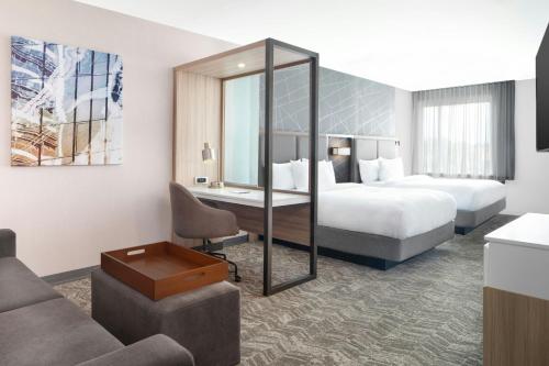 a hotel room with two beds and a desk at SpringHill Suites by Marriott Columbia near Fort Jackson in Columbia