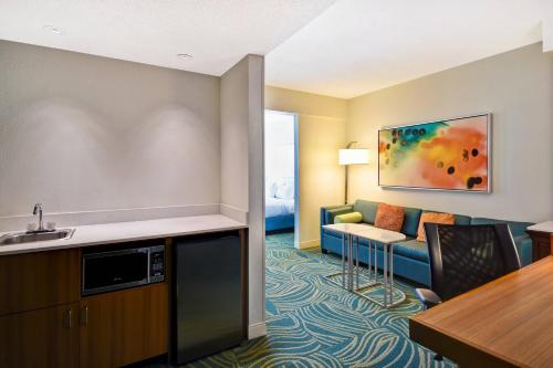 a hotel room with a couch and a table at SpringHill Suites by Marriott Baltimore BWI Airport in Linthicum Heights