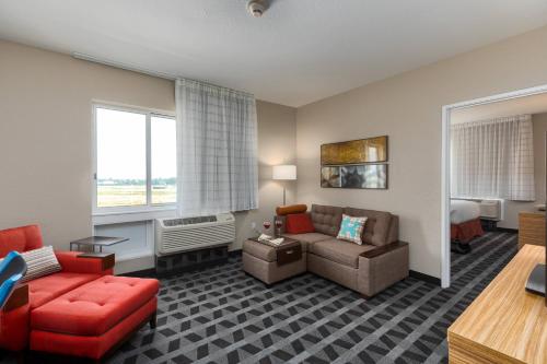 a living room with a couch and a chair at TownePlace Suites by Marriott Owensboro in Owensboro