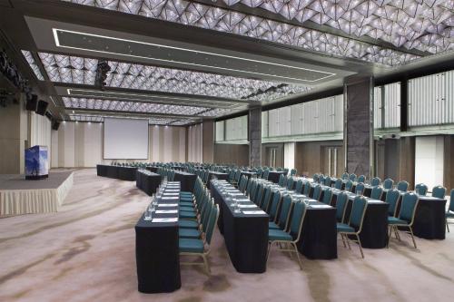 a large room with rows of tables and chairs at Le Meridien Kota Kinabalu in Kota Kinabalu