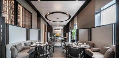 a restaurant with couches and tables and windows at The Ritz-Carlton, Xi'an in Xi'an