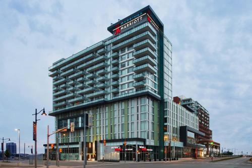 a tall building with a hotel sign on top of it at Toronto Marriott Markham in Markham