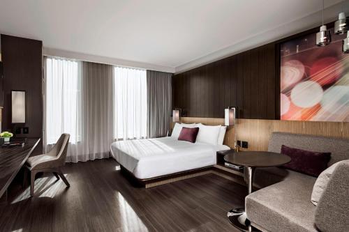a hotel room with a bed and a couch at Toronto Marriott Markham in Markham