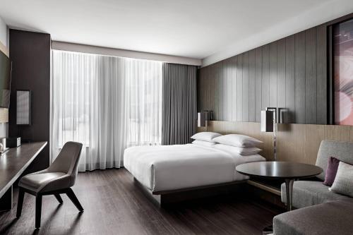 a hotel room with a bed and a table and a couch at Toronto Marriott Markham in Markham